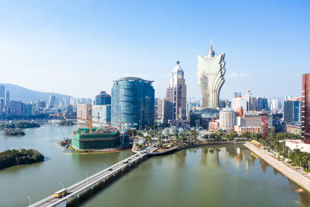 Macau City, Drone view Urban landscape of Macau with famous traveling tower under blue sky near river in Macao, Asia. macao photos stock pictures, royalty-free photos & images