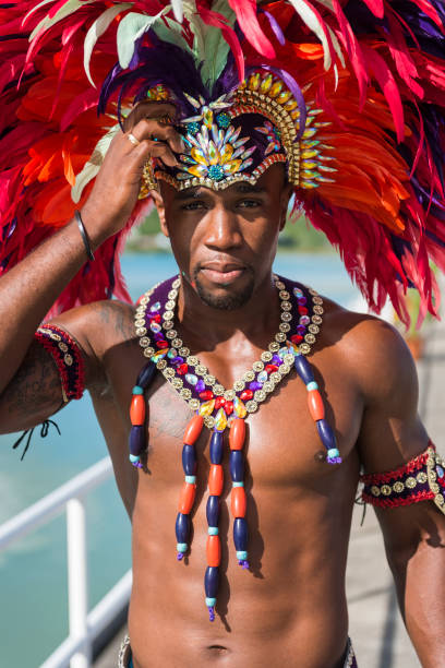 A man in the port of St. John's on the Caribbean island of Antigua stands on the dock to welcome cruise ship passengers onto the island.