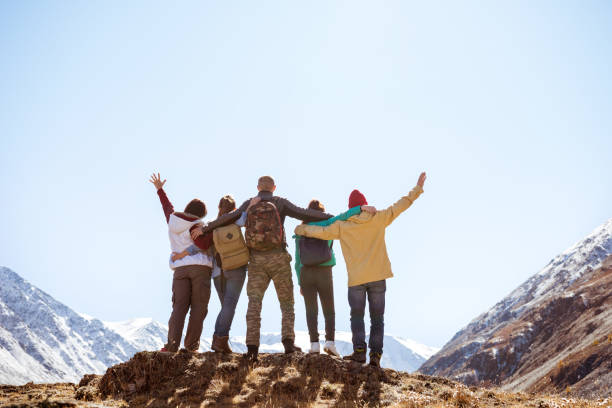 istock Happy friends hugging together mountains 1189969485