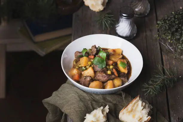 Photo of traditional irish beef and guinness beer stew with carrots, potatoes and green peas