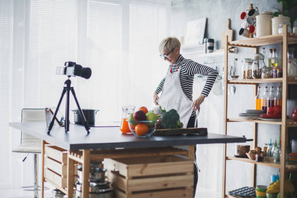 istock Food blogger putting on an apron while filming a video 1189971935