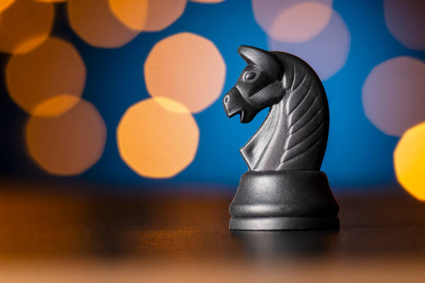 istock black horse chess piece over a colorful bokeh 1189972575