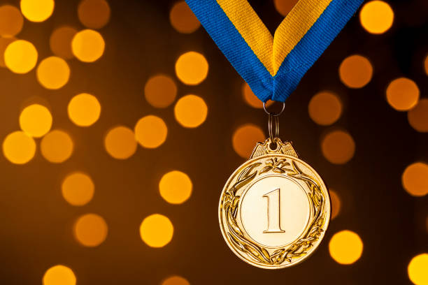 istock Gold champion or winners medallion on a ribbon 1189972623