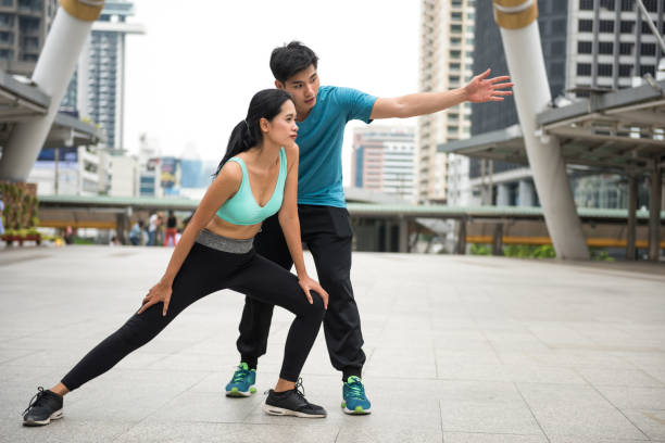 istock man coach woman to stretching before running 1189972930