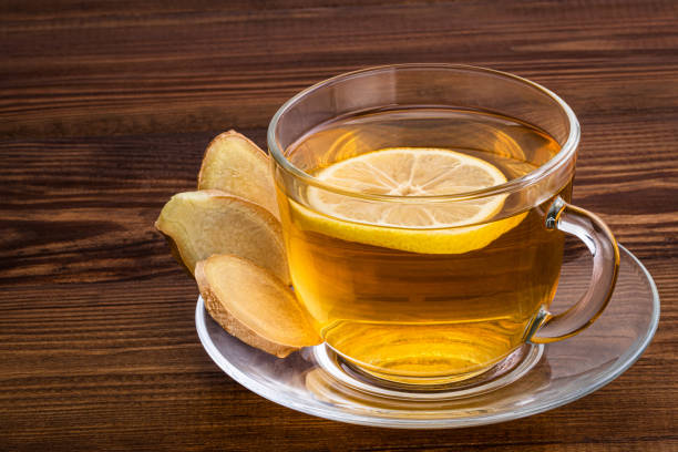 istock Cup of Ginger tea with lemon and ginger root on a wooden background with copy space 1189974377