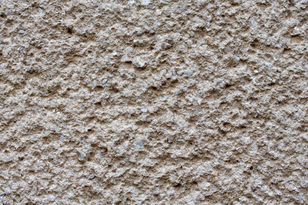 istock Facade plaster texture in slovak called Brizolit. Single layer sprayed cement plaster wallpaper. Single-ply monolithic plaster decorative background. Exterior building facade structure backdrop. 1189975054