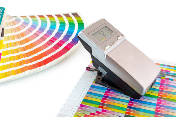 istock Printed color swatch, density meter and paint guide isolated on white background - clipping path. Measuring density of magenta color in printing process. Densitometer and ink sampler. Color checking. 1189975366
