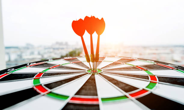 istock Dart board with three darts outdoors 1189976668
