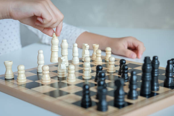 istock a girl learn how to play chess game 1189978007