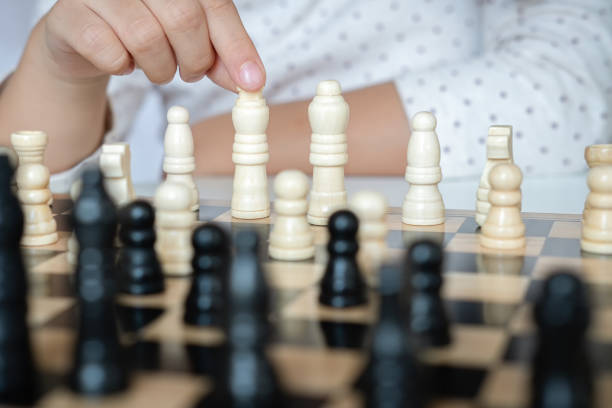istock a girl learn how to play chess game 1189978013