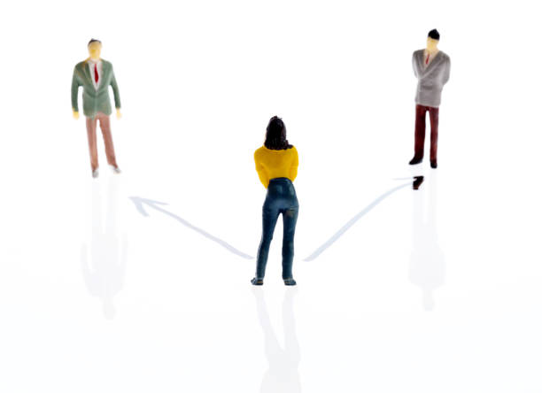istock Three figurines with arrow symbol on white background 1189978327