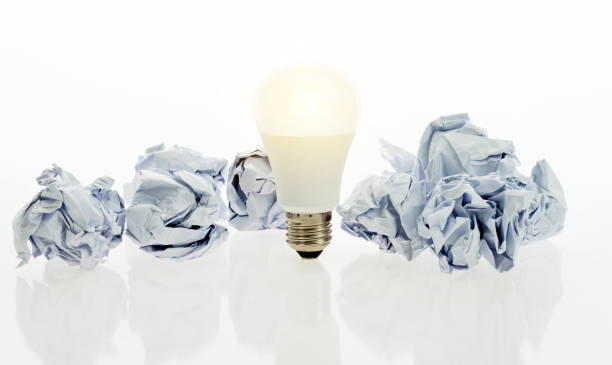istock Light bulb and paper crumpled balls 1189979032