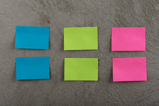 istock Many colorful sticky note on grey cement background. Copy space 1189980792