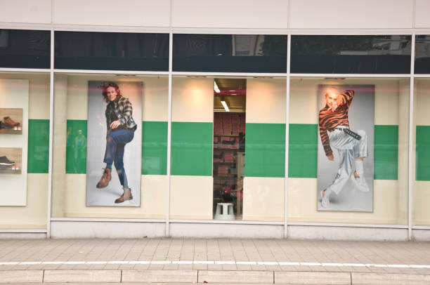 Customers walking past a Deichmann retail store with ad boards in Dortmund Hoerde - Germany.. Deichmann SE is a major German footwear retail chain founded 1913 in Essen, North Rhine-Westphalia, Germany. In 2017, business newspaper, Handelsblatt, cited it the biggest shoe vendor in Europe.