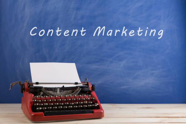 istock writer's workplace - red typewriter on blue blackboard background with text 