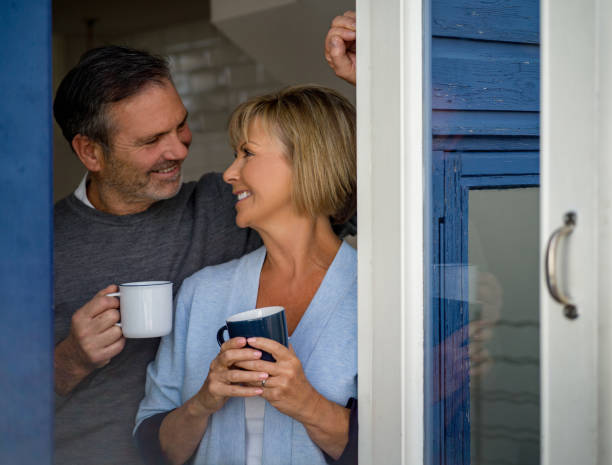 istock Loving couple at home drinking coffee and smiling 1189981499