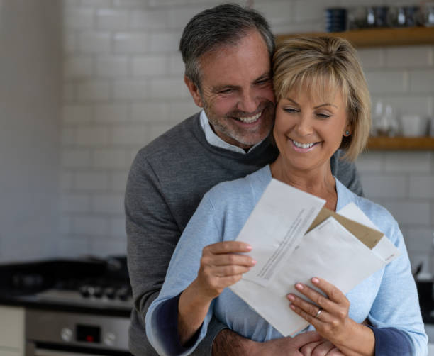 istock Senior couple checking the mail and looking happy 1189981516