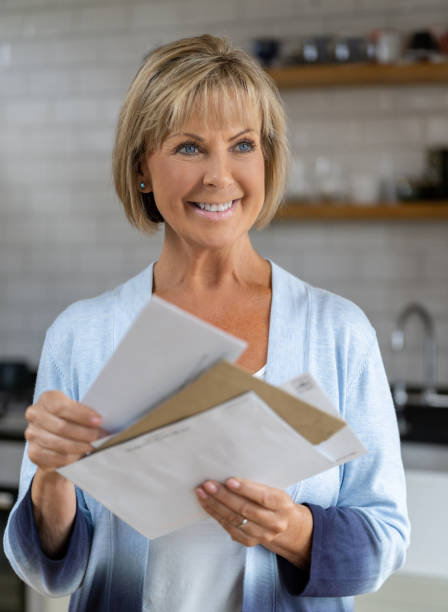 istock Senior woman at home checking the mail 1189981544