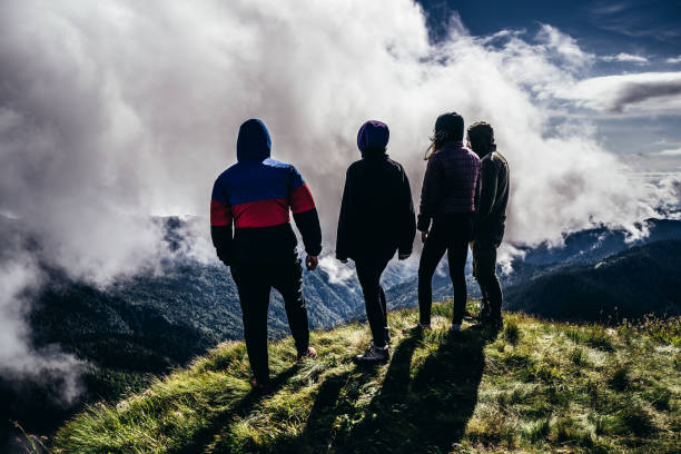 istock The four people standing on a mountain against beautiful clouds 1189983667