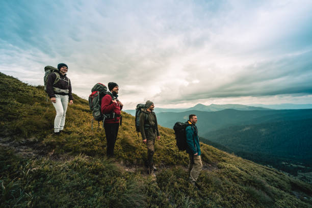 istock The four hikers with backpacks standing on the mountain 1189984360