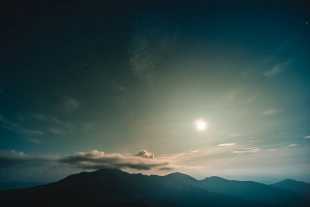 istock The moonlight above the beautiful mountain landscape 1189984481