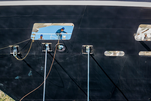 Kotor, Montenegro - September 18, 2013: Three deckhands at work during the docking of the cruise ship Azamara Quest in Kotor, Montenegro.