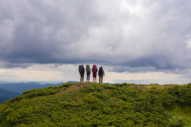 istock The four active people standing on the picturesque mountain 1189984901