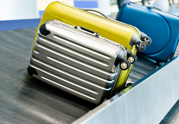 istock Suitcases on conveyor belt in the airport 1189986140