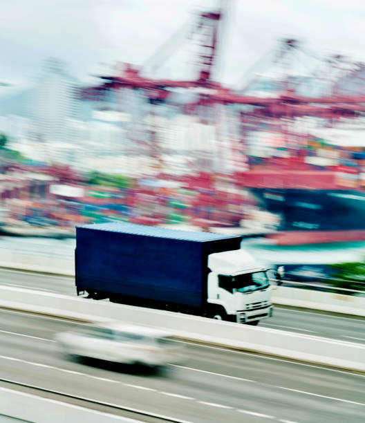 istock Blue truck leaving the harbor 1189986824