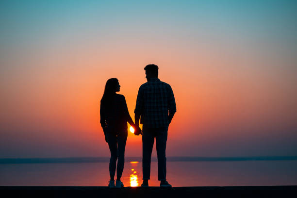 istock The couple against the beautiful sunset 1189987271