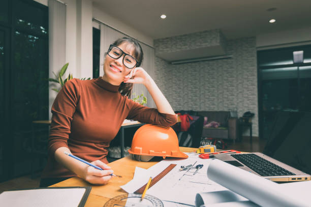 Female architect working with new startup project at home office. stock photo