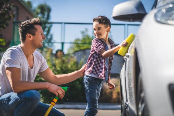 istock The daddy and his son cleaning the car 1189988022