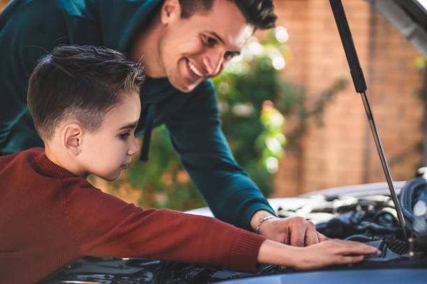 istock The father and son checking under the car hood 1189988053