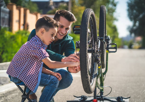 istock The father and son checking the bicycle chain 1189988057