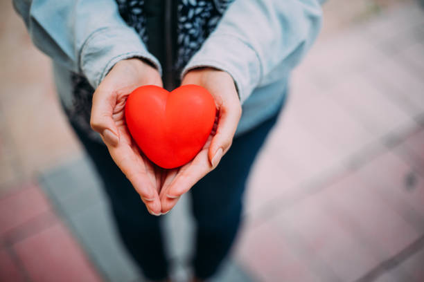 istock Woman Holding Showing Red Heart 1189988357