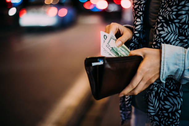 istock Woman is taking out money from wallet 1189988778