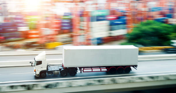 istock White truck leaving the harbor 1189988877
