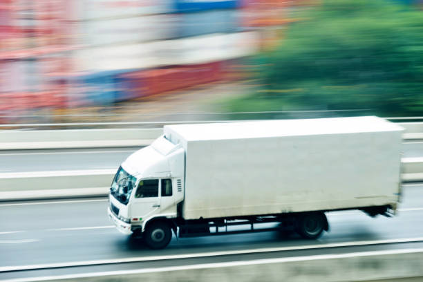 istock White truck leaving the harbor 1189989668