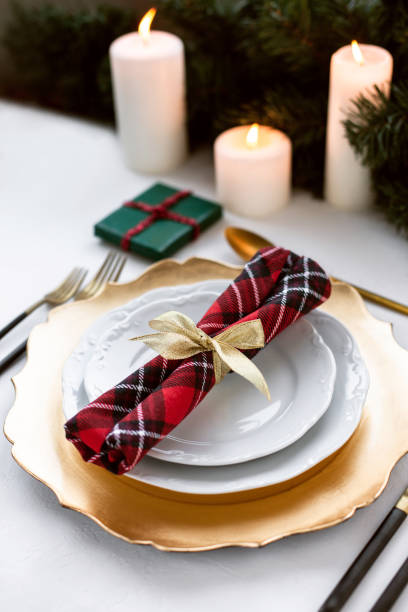 istock Beautiful Christmas table setting decorated with candles and fir. 1189989844