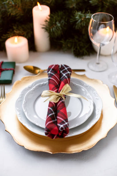 istock Beautiful Christmas table setting decorated with candles and fir. 1189989856
