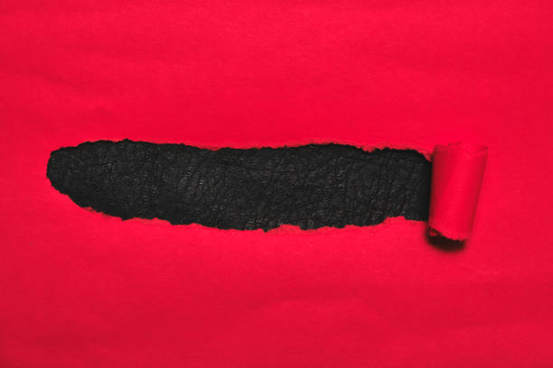 istock Red torn paper cover with black background. 1189991648
