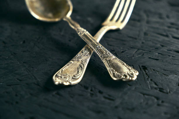 istock Old Cutlery spoon and fork on black wooden table. 1189991687