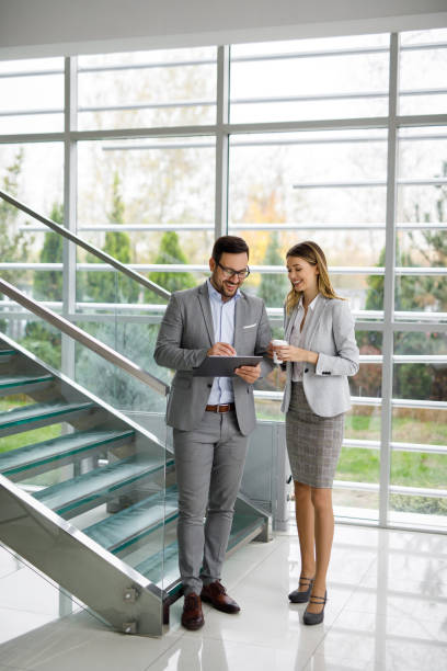 istock Business executives discussing over digital tablet 1189992303