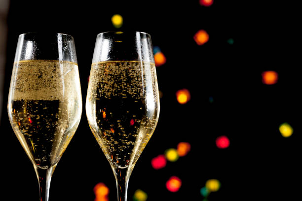 istock Two champagne glasses and lights unfocused 1189993287