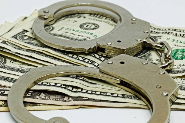 istock money and handcuffs 1189993608