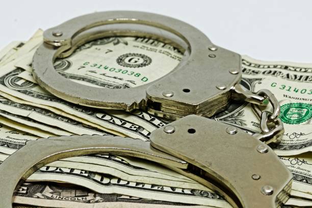 istock money and handcuffs 1189994268