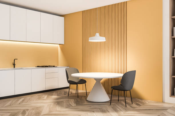 istock Yellow and white kitchen with round table 1189994711