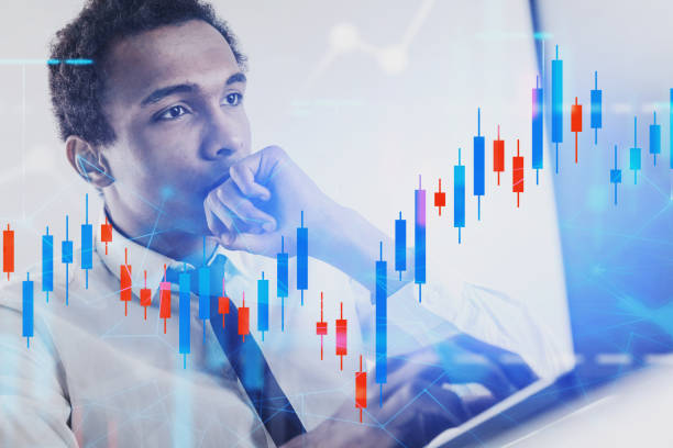 istock Serious African man with laptop, graph 1189994855