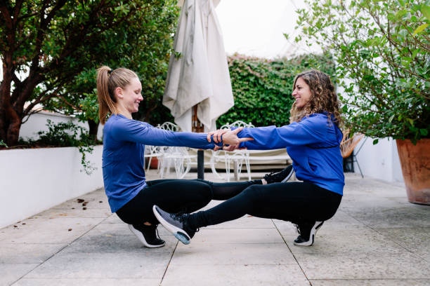 istock Two young women doing exercise together on a terrace 1189995245