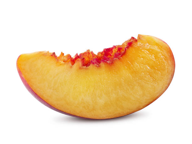 istock Unpitted, smooth-skinned nectarine fruit slice isolated on white background with copy space for text or images. Close-up shot 1189996370